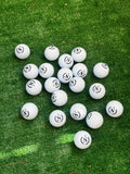 Custom logo laser engraved golf balls on green grass